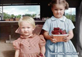 Photo of two young Knaus girls (unnamed) holding strawberries on the farm.