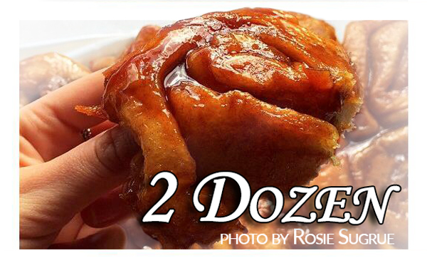 Photo of a cinnamon roll with the words "2 dozen"